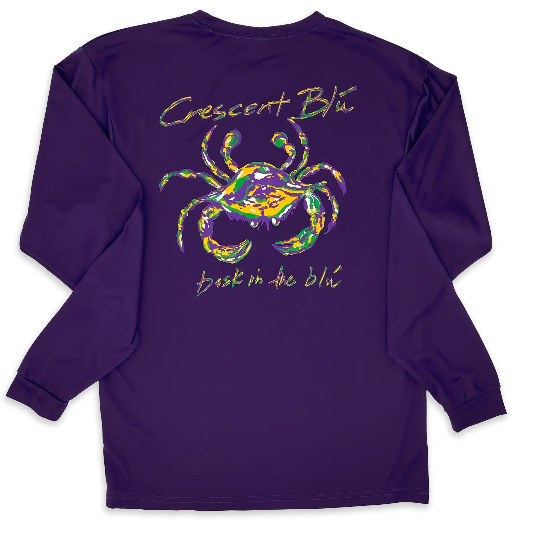 A long sleeve purple Mardi Gras tee shirt with Crescent Blú written above  a purple, green, and gold crab with the words, "bask in the blu" on the bottom.