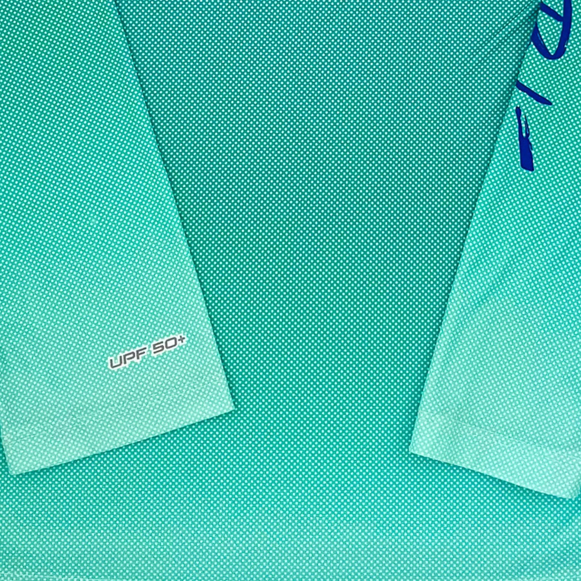 Close up of the dot gradient pattern of shirt with sleeve showing UPF 50+ fabric type