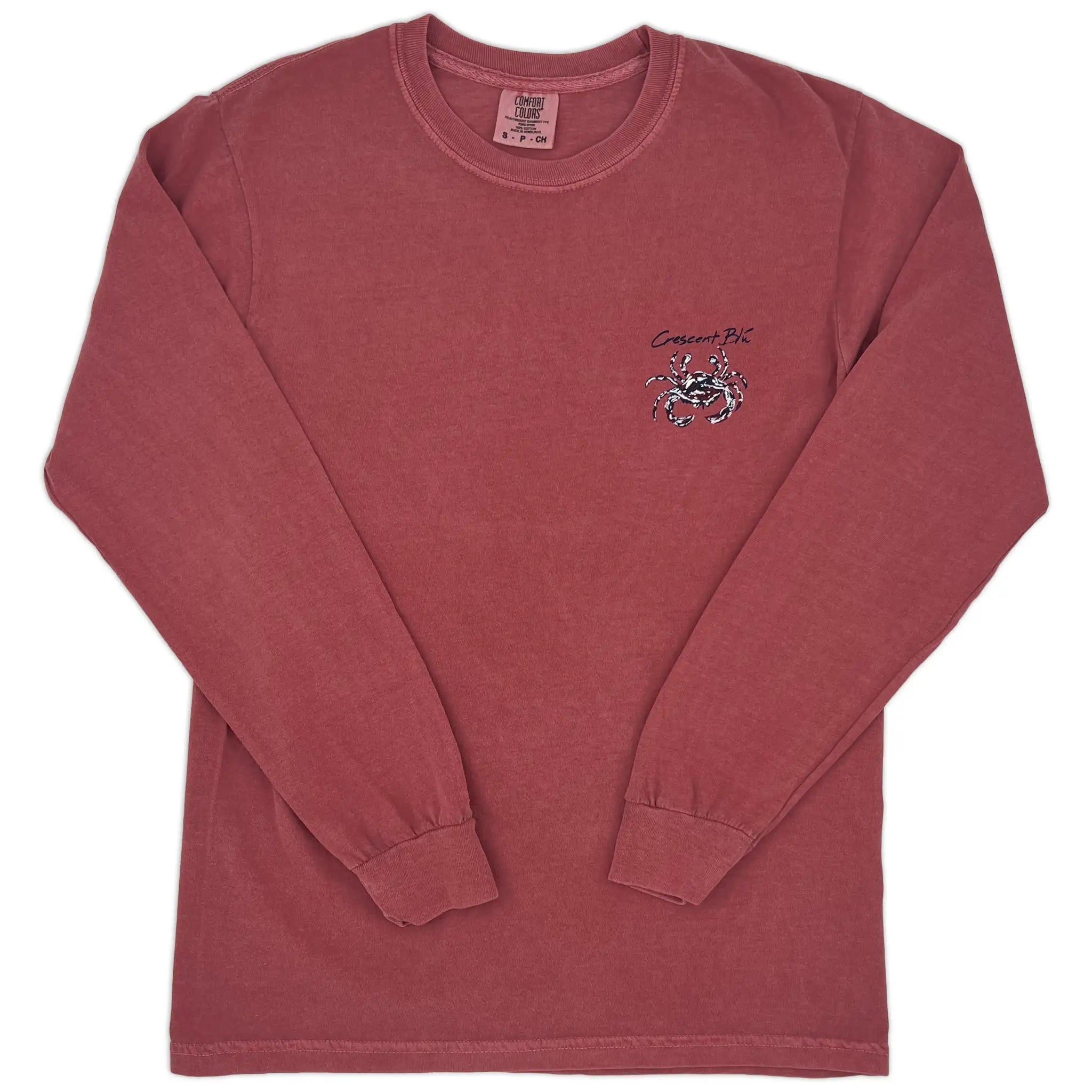 A view of the front of a long sleeve crimson t-shirt with small crimson and navy crab logo on the front left chest