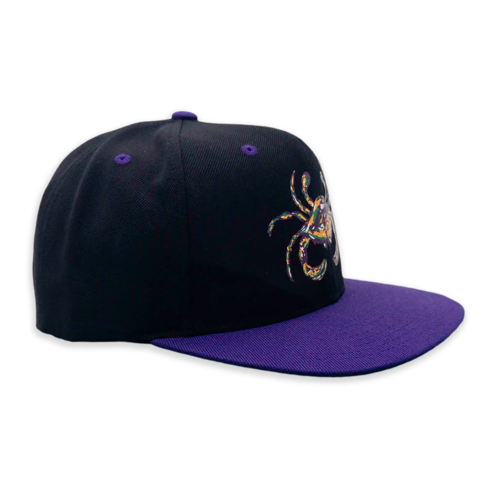 Side view of Mardi Gras flat bill snapback hat in black with purple bill and Crescent Blú crab design