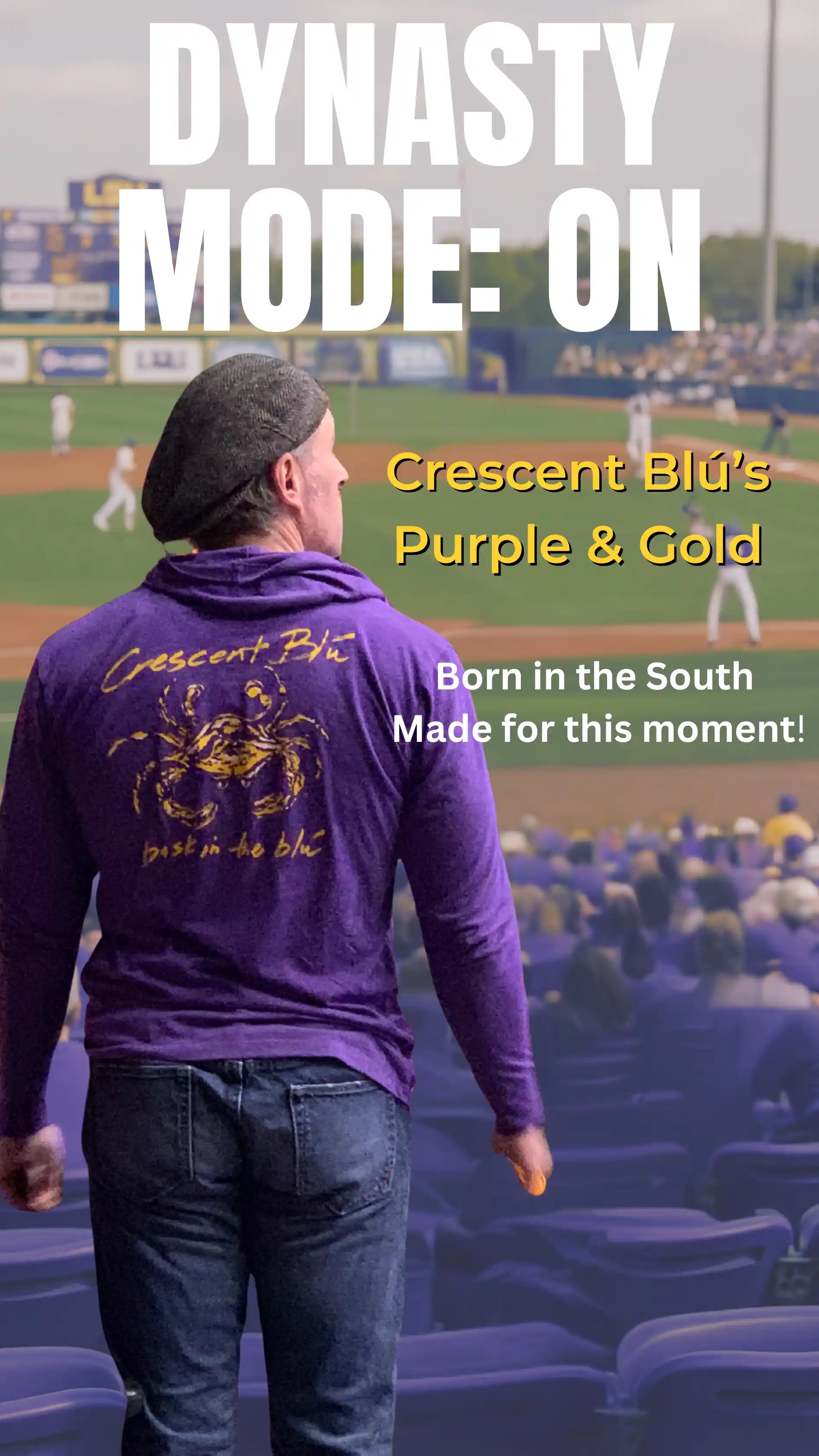 Crescent Blú purple long sleeve crab shirt worn at a stadium with bold white and gold text reading “Dynasty Mode: ON” and “Born in the South, Made for this moment”