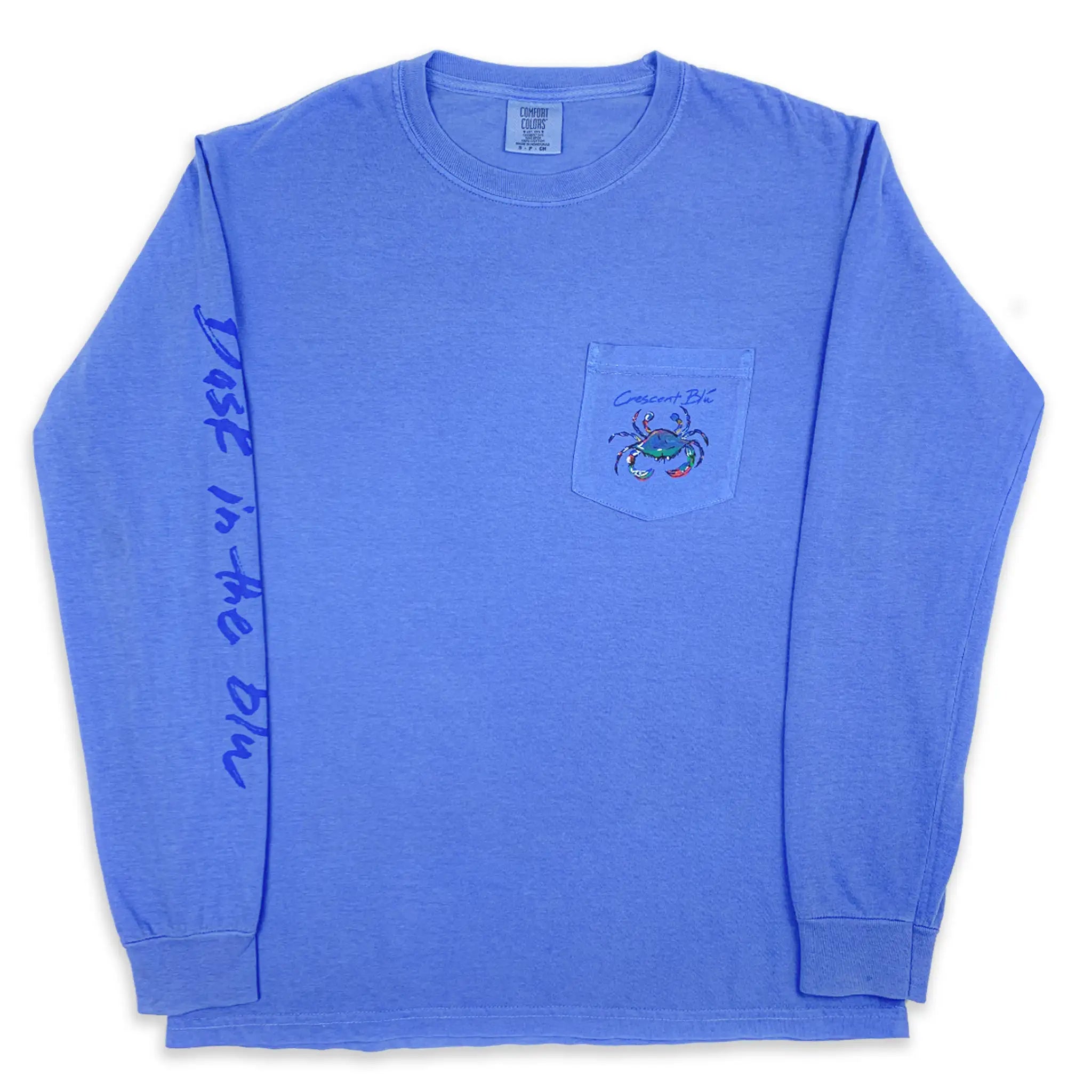 Front of an blue long sleeve Crescent Blu t-shirt with small multi-colored crab logo on the front left chest pocket and Bask in the Blu printed on the right sleeve.