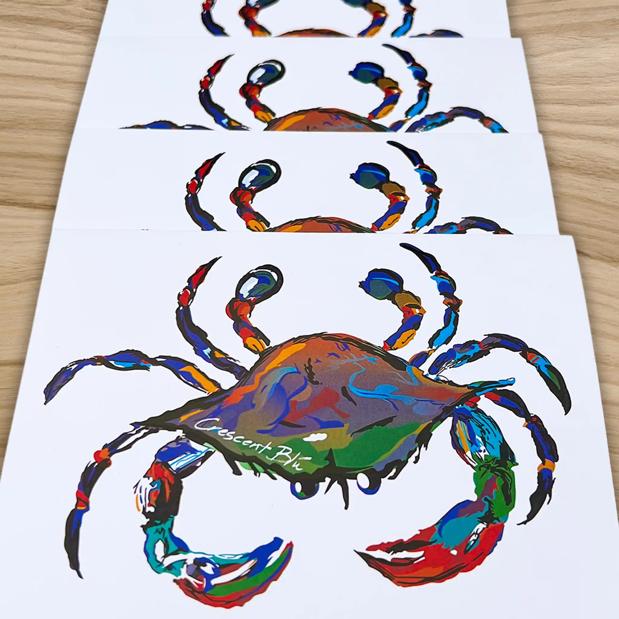 Crescent Blue Signature Crab notecards on a wooden desktop.