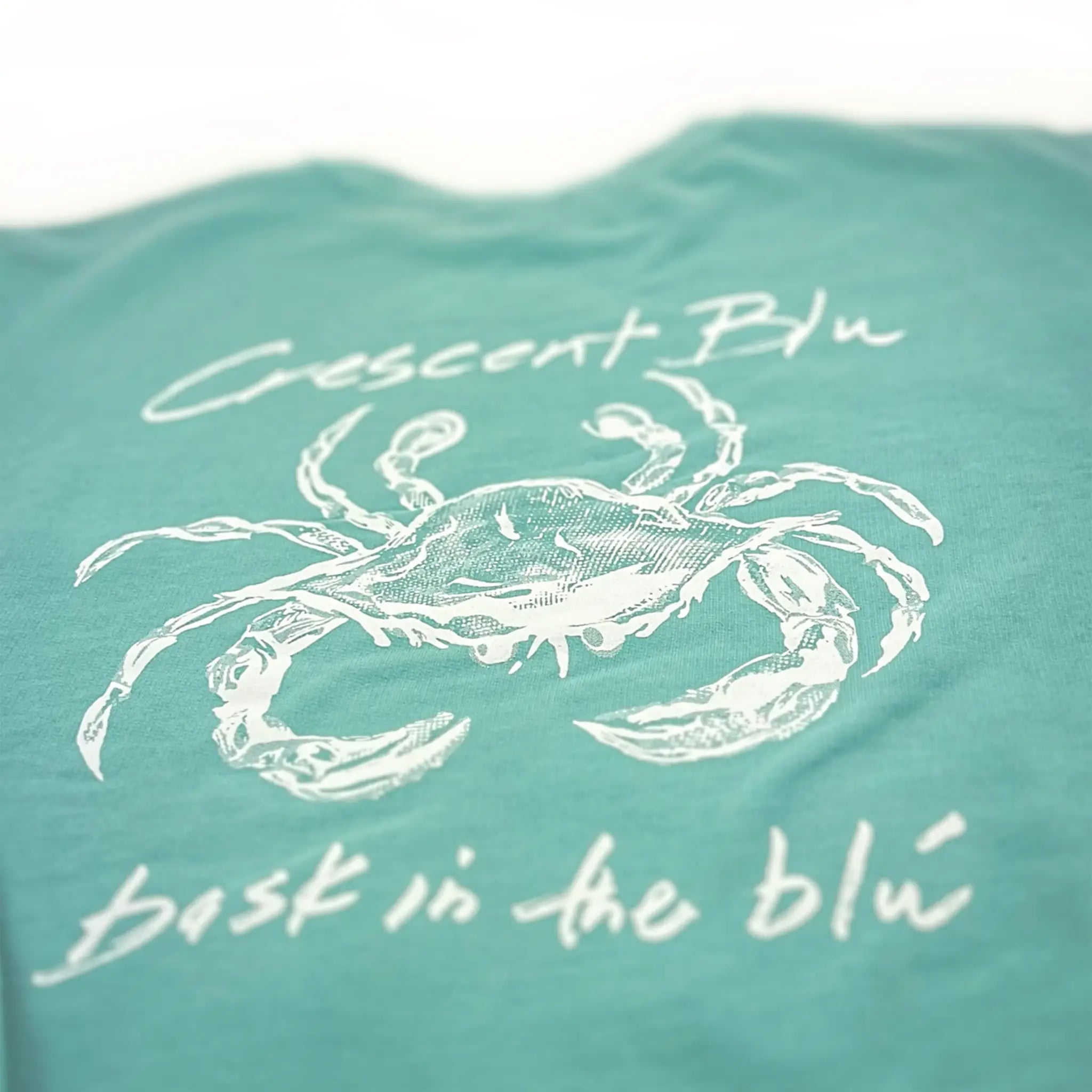 Close-up detail of Crescent Blú Sneaux Crab crew neck sweatshirt in chalky mint