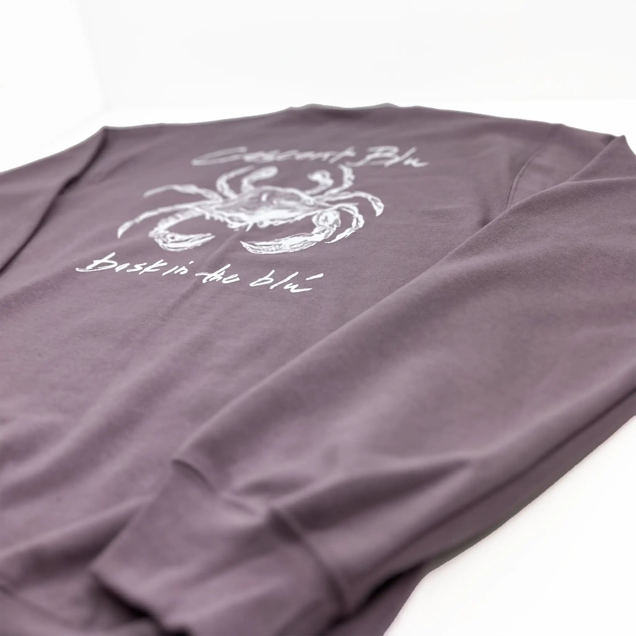 Detail view of sleeve cuff on Crescent Blú Sneaux Crab crew neck sweatshirt in paragon blue