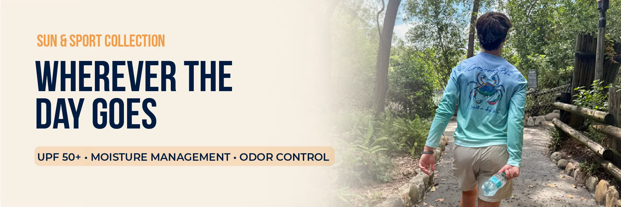 Sun & Sport UPF 50+ performance shirt with Signature Crab design worn on a wooded outdoor path