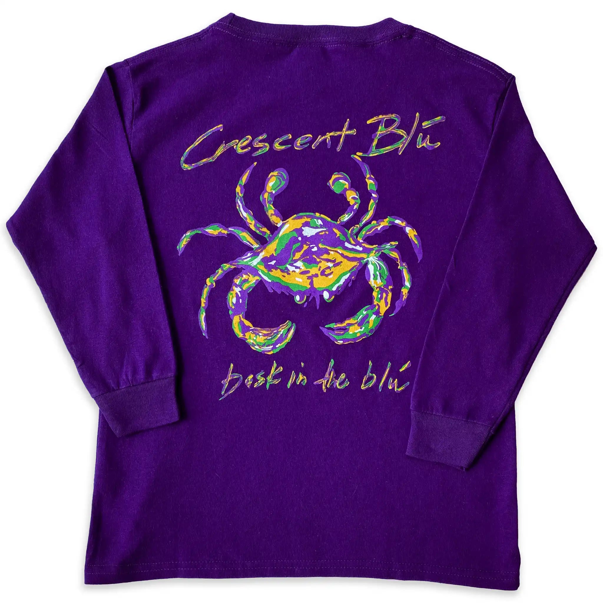 A purple, green, and gold Mardi Gras crab on the back of a long sleeve purple shirt. 