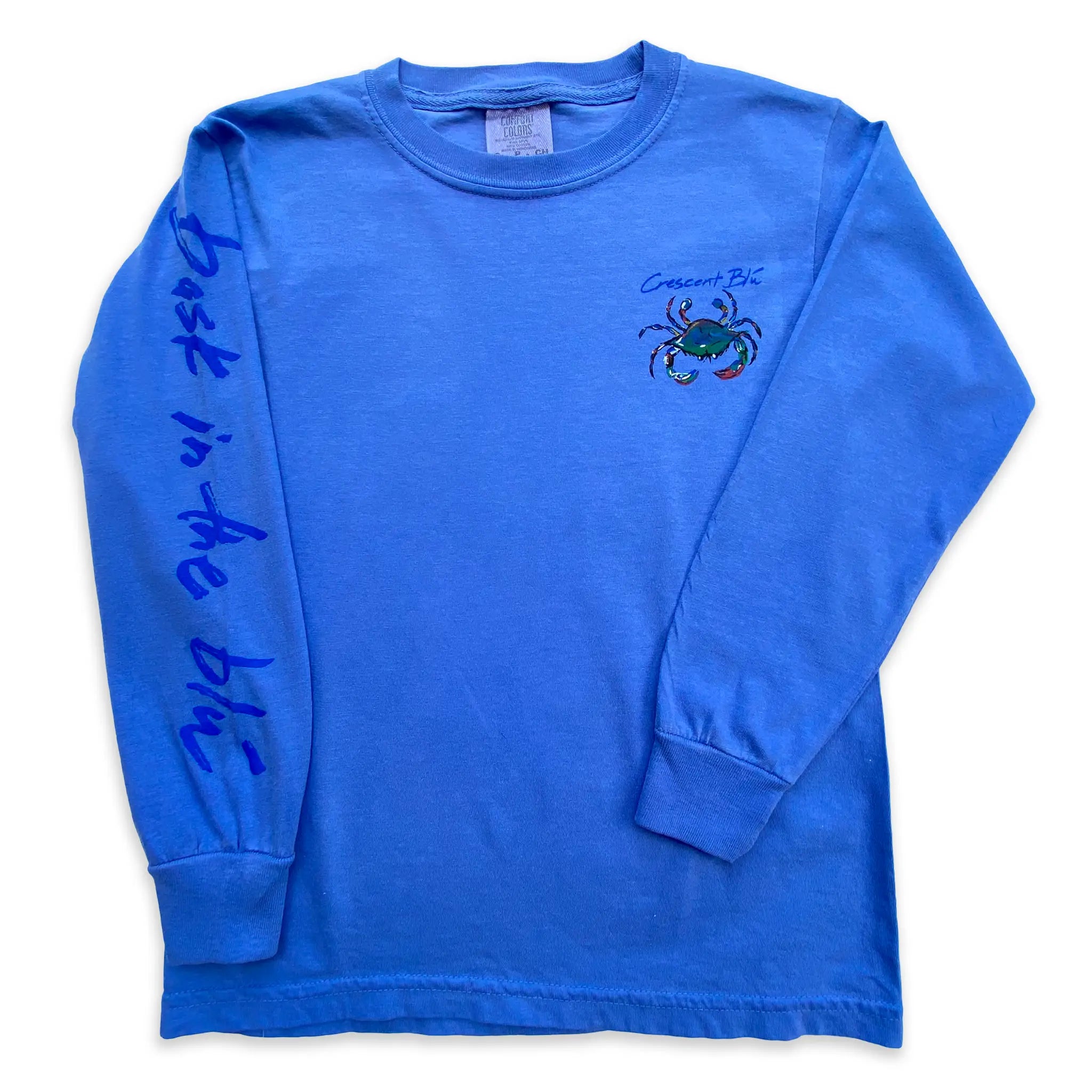 A youth long sleeve flo blue t-shirt with a small Crescent Blú logo on the front and bask in the blu written on the sleeve.