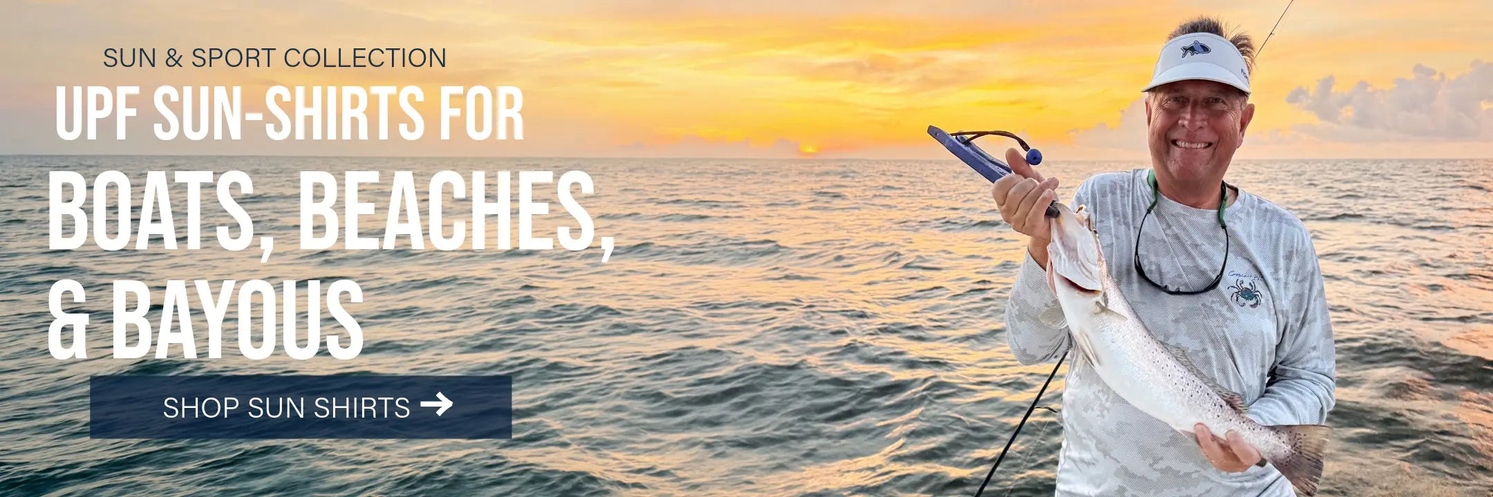 Man wearing a Crescent Blú Signature Crab UPF sun shirt while holding a fish on a boat at sunset.