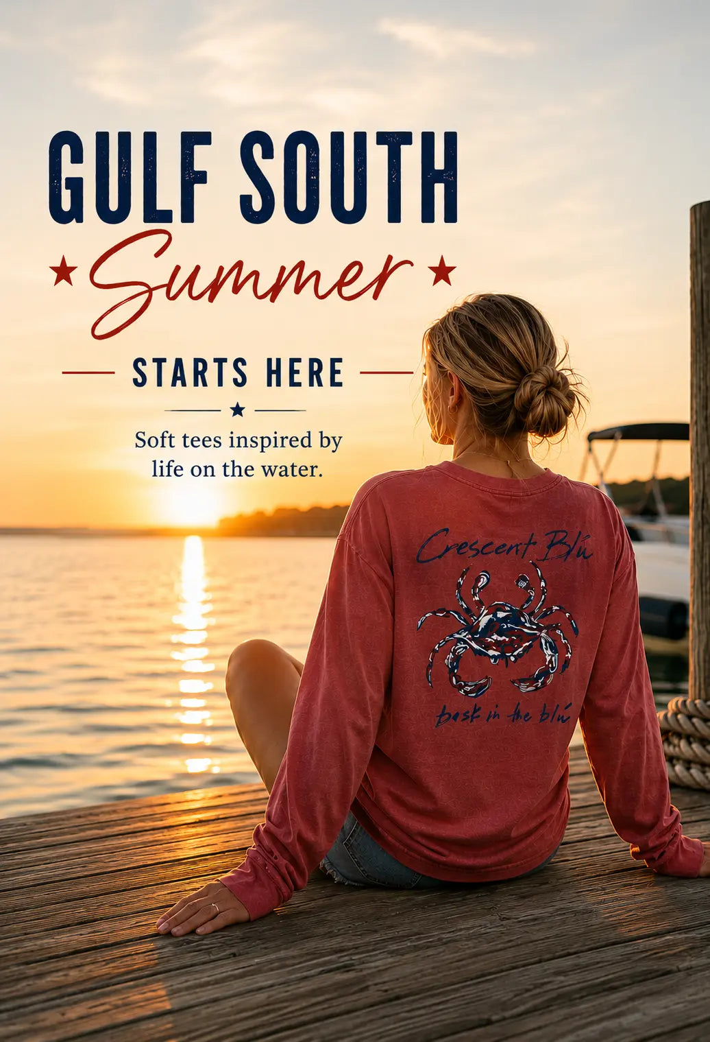 Woman sitting on a dock at sunset with wearing a red, white, and blue crab long sleeve shirt and 'Gulf South Summer' text.