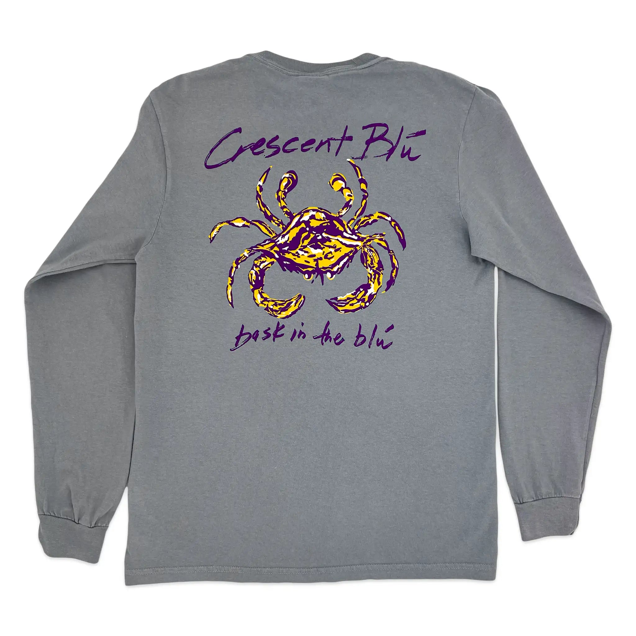 A gray long-sleeve t-shirt shown from the back, featuring a purple and gold of crab with the text 'Crescent Blu' and 'back in the blu' in purple handwritten text