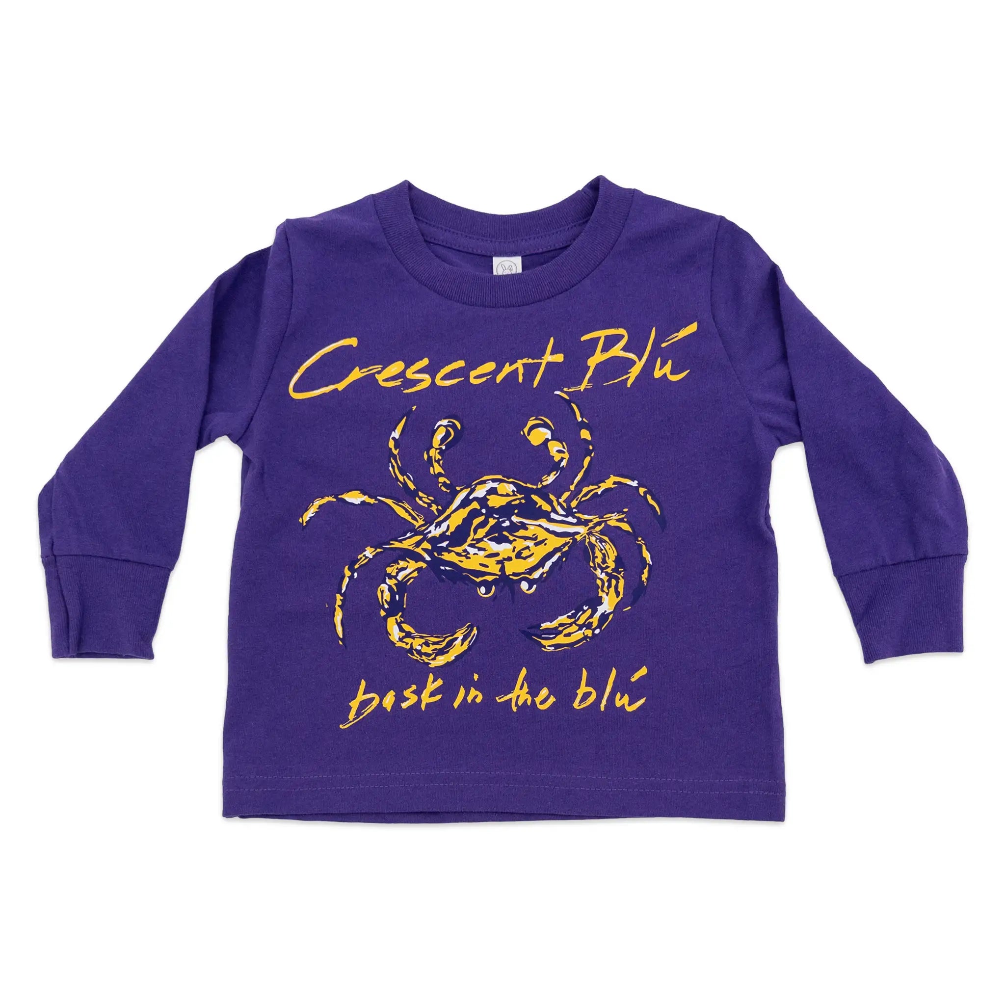 The front of a purple toddler long-sleeve crewneck shirt graphic of a crab with the text 'Crescent Blu' above and 'bask in the blu' below.