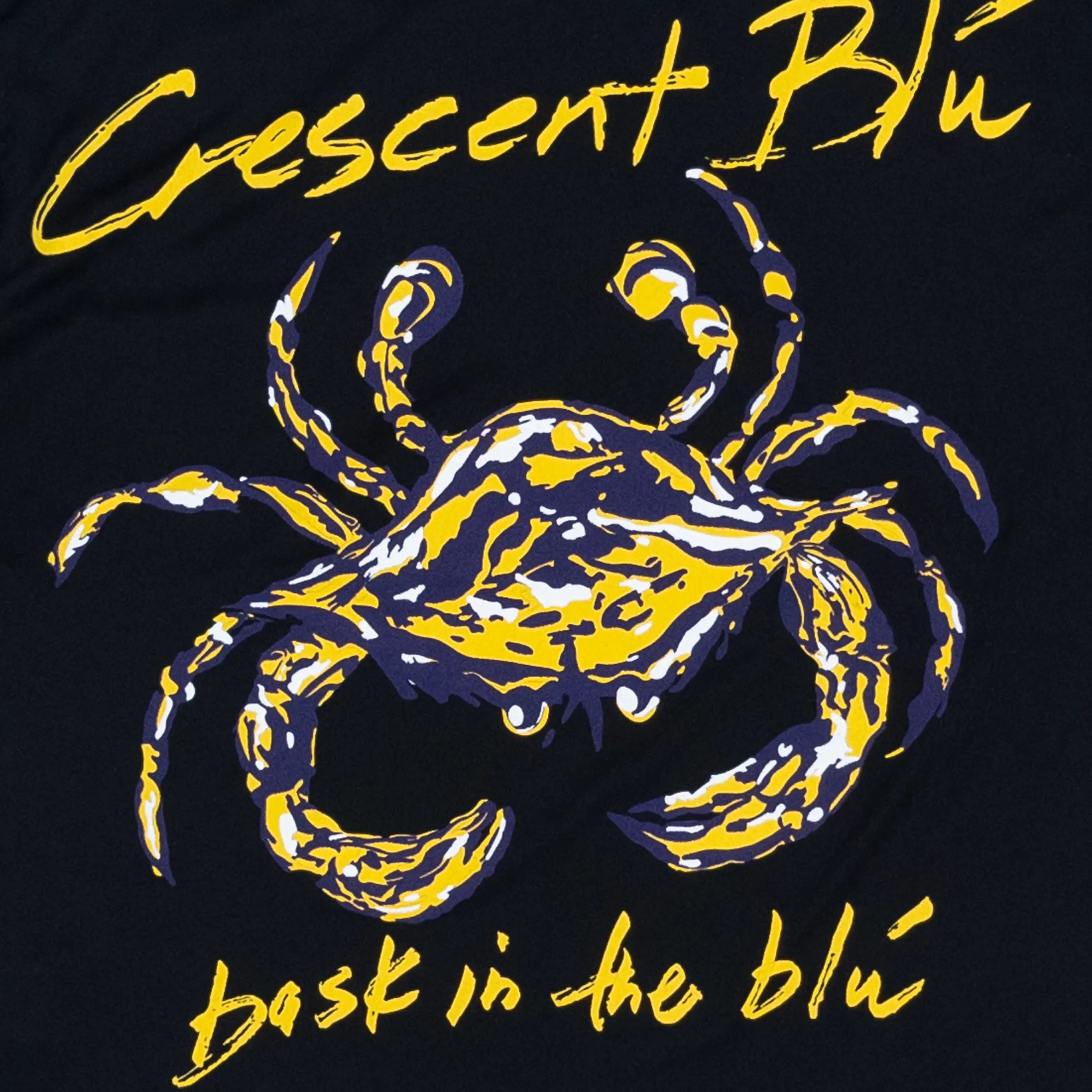 A purple and gold crab on the back of a black youth tee.