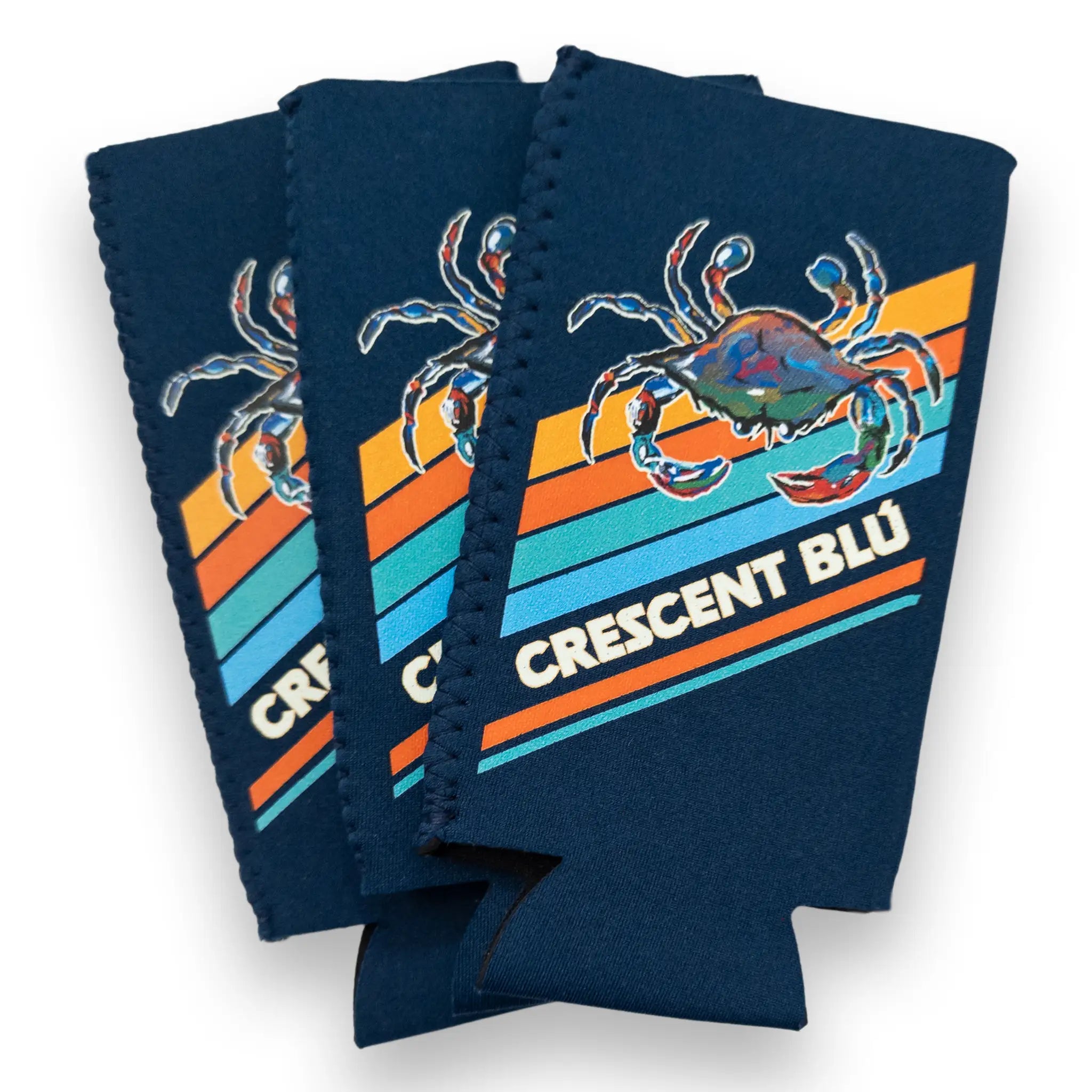 Three navy blue slim can coolers with orange and blue slanted stripes and a colorful blue crab design.