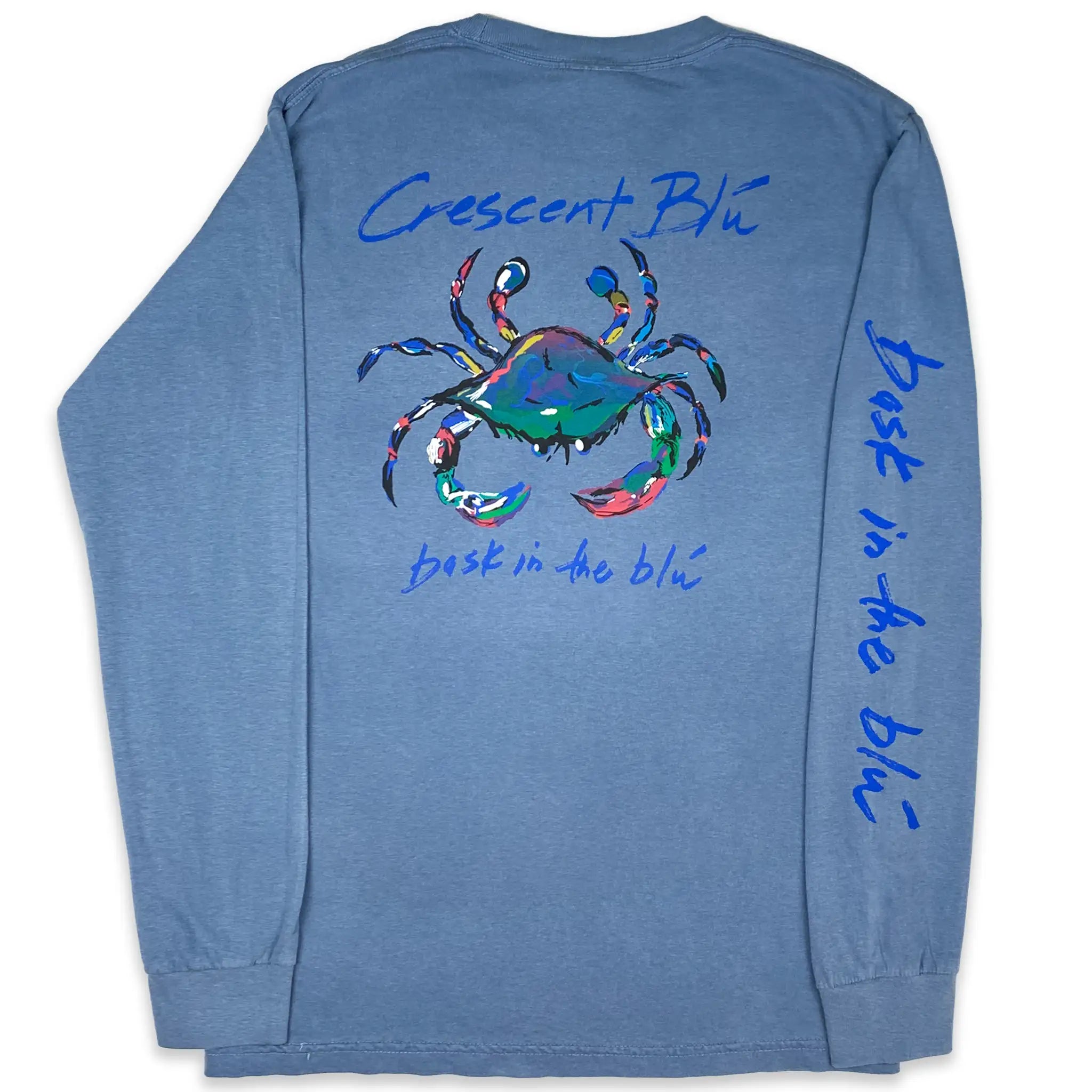View of back of long sleeve, blue Blue jean colored t-shirt with large multi-colored Crescent Blu crab logo printed on back and bask in the Blu printed on the right sleeve. 