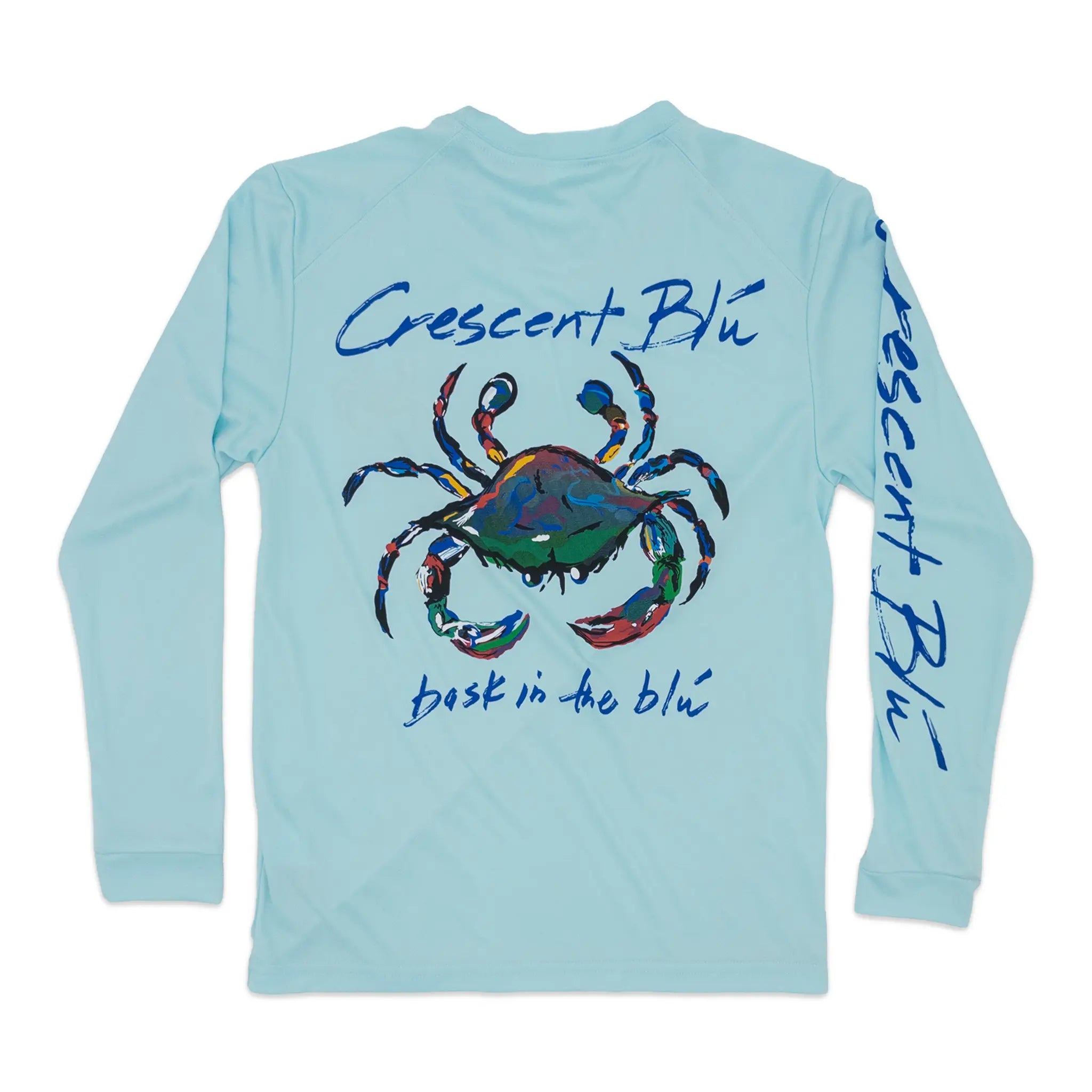 A light blue long-sleeve youth performance shirt shown flat against a white background, featuring a colorful painted crab graphic on the back with the text 'Crescent Blu' and 'bask in the blu'