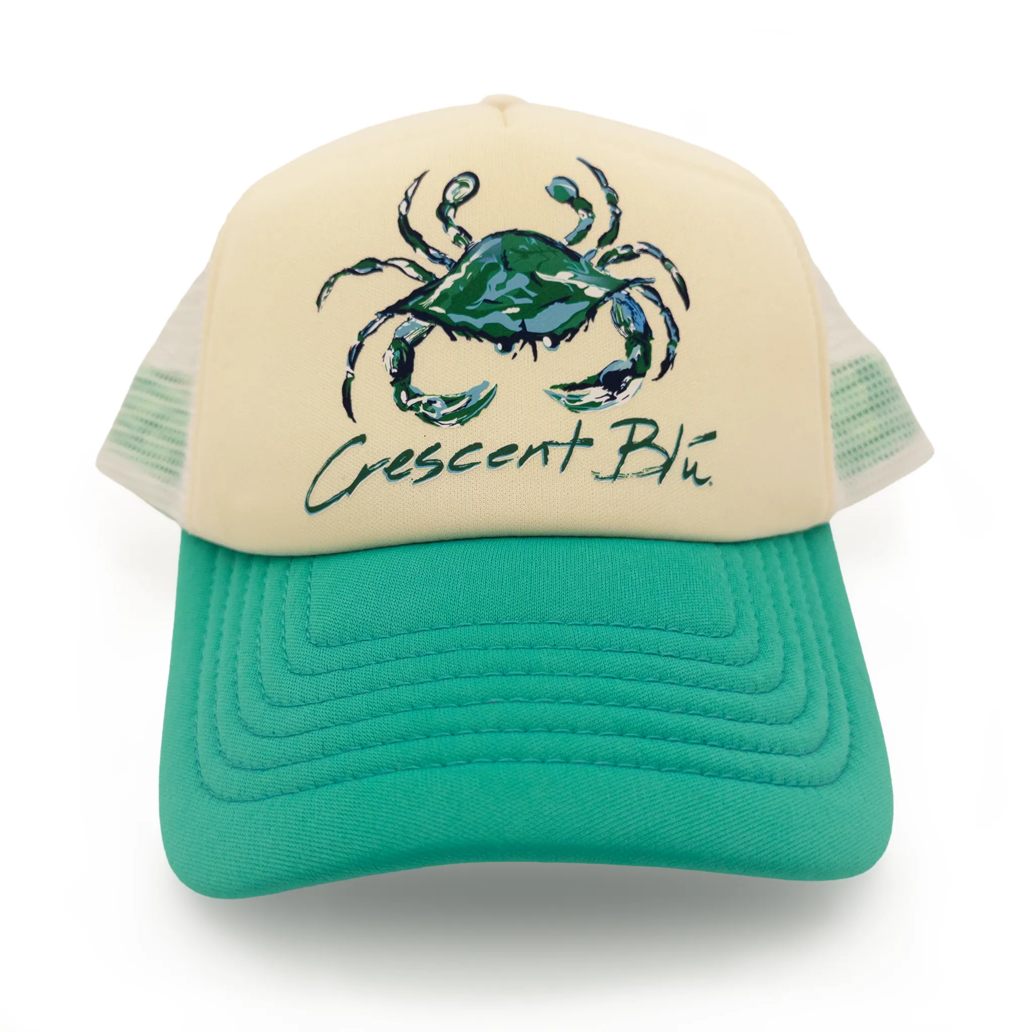 The front of an ivory foam womens trucker hat with a jade bill and a green and blue Crescent Blu crab design on the foam. 