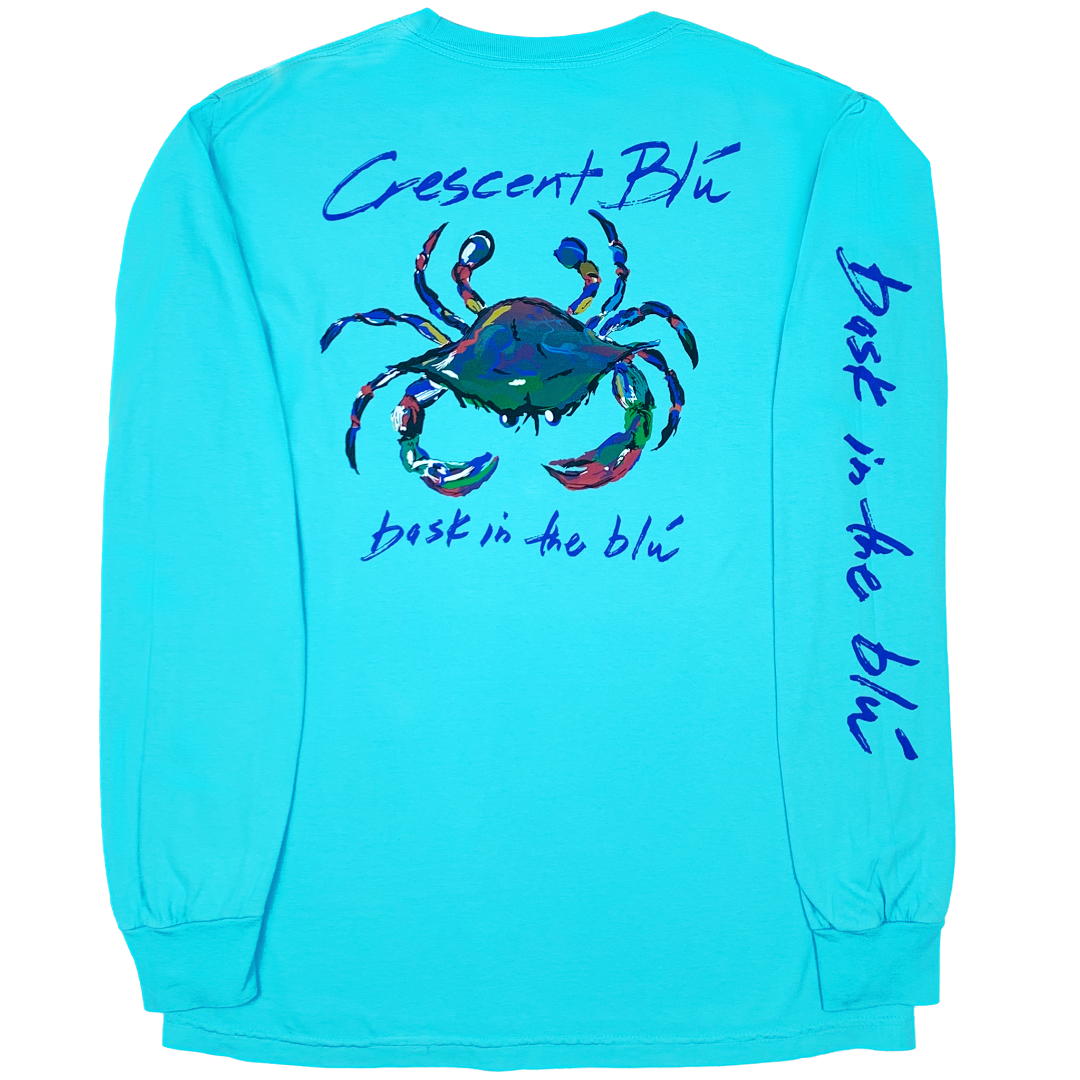 Back view of an adult long sleeve Crescent Blu adult t-shirt with large multi-colored crab logo printed on upper half. Bask in the Blu is printed on the back and along the length of the right sleeve. Shirt is Lagoon Blue in color. 