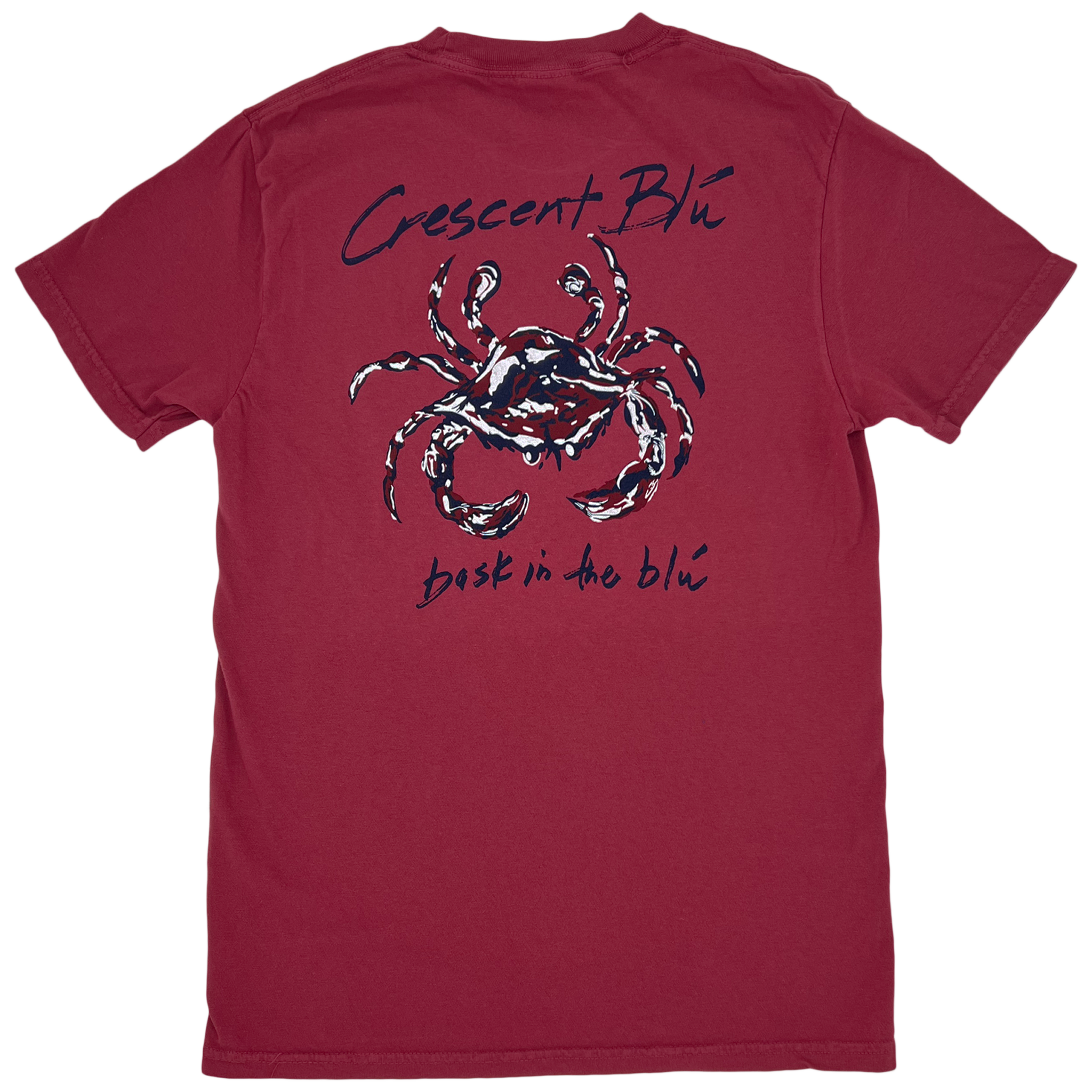 The back of a red t-shirt. Crescent BLú is written above a crimson, navy, and white crab. Bask in the blu is written below the crab.
