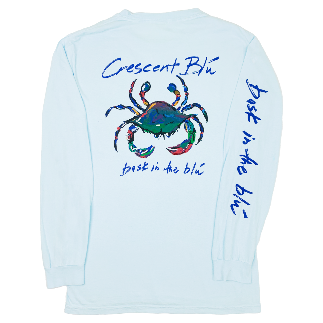 Adult long sleeve Chambray colored t-shirt with Crescent Blu, Bask in the Blu, and large Signature crab logo printed on the back and Bask in the Blu printed along the right sleeve.  