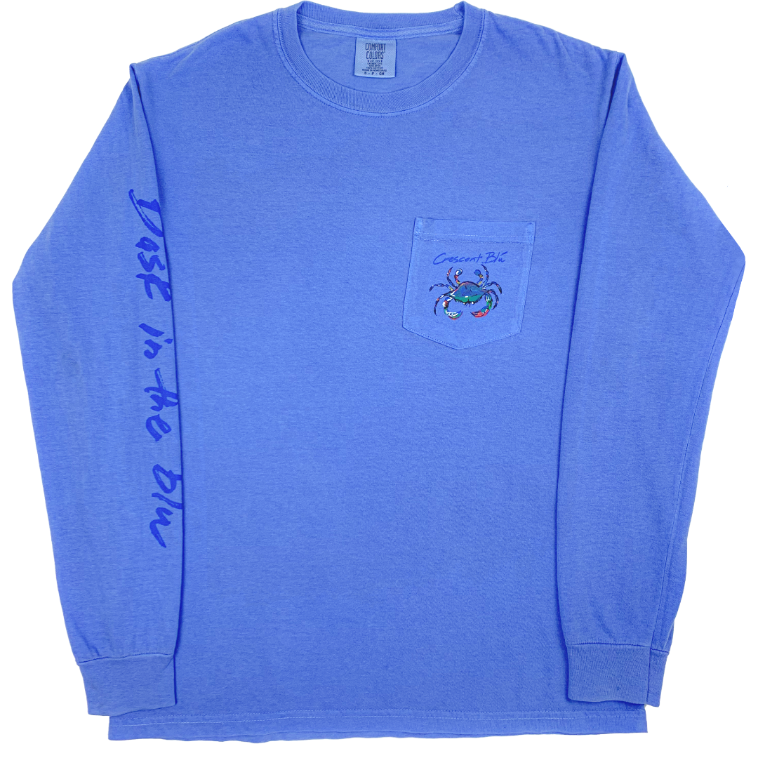 Front of an adult long sleeve Crescent Blu T-shirt with small multi-colored crab logo on the front left chest pocket and Bask in the Blu printed on the right sleeve. Shirt is Flo Blue color.