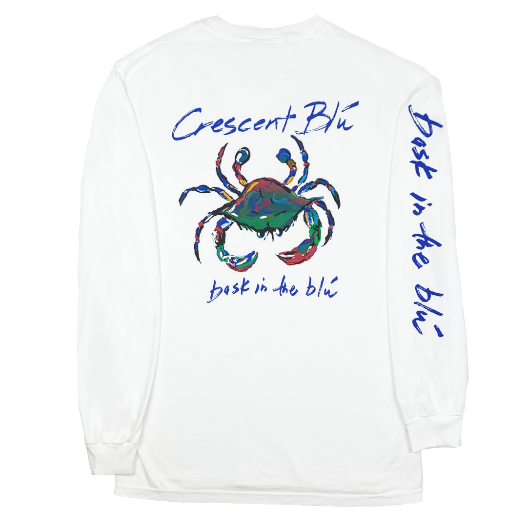 View of the back of a white adult long sleeve tee with a large multi-colored crab logo on the center and Bask in the Blu printed down the length of the right sleeve. 
