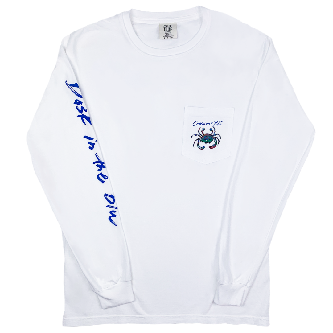 Image of the iconic adult white long sleeve Crescent Blu T-shirt with small Crescent Blu multi-colored signature crab logo on the front left pocket and Bask in the Blu printed along the length of the right sleeve. 