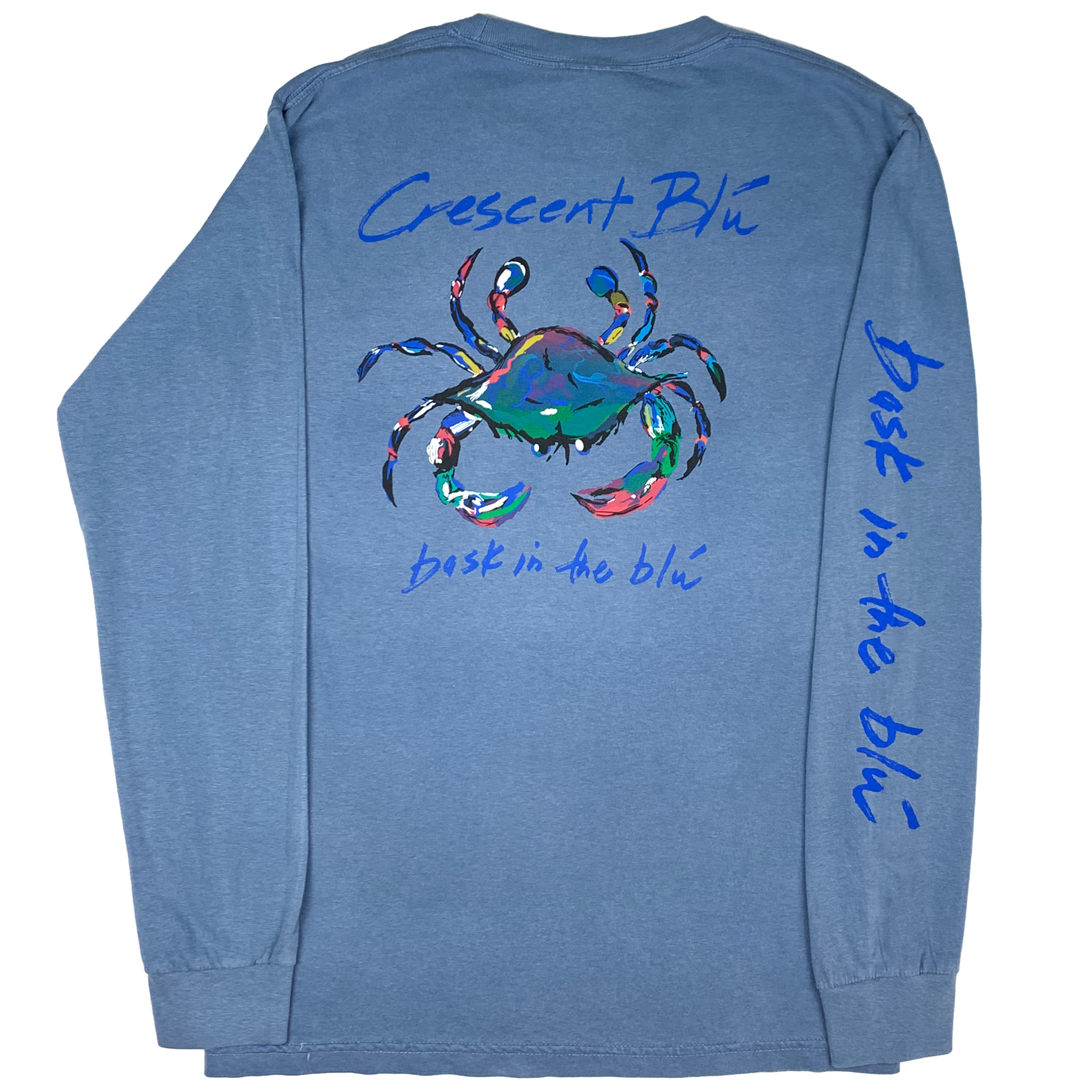 View of back of adult long sleeve, blue jean colored, t-shirt with large multi-colored Crescent Blu Signature Collection crab logo printed on back. Bask in the Blu tagline printed on the right sleeve. 